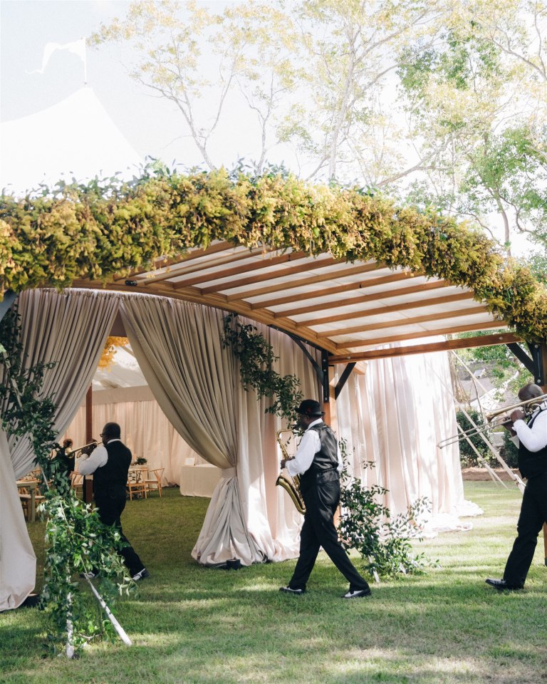 Wedding guests walking through a floral installation designed by Topher Mack Floral & Events in Atlanta
